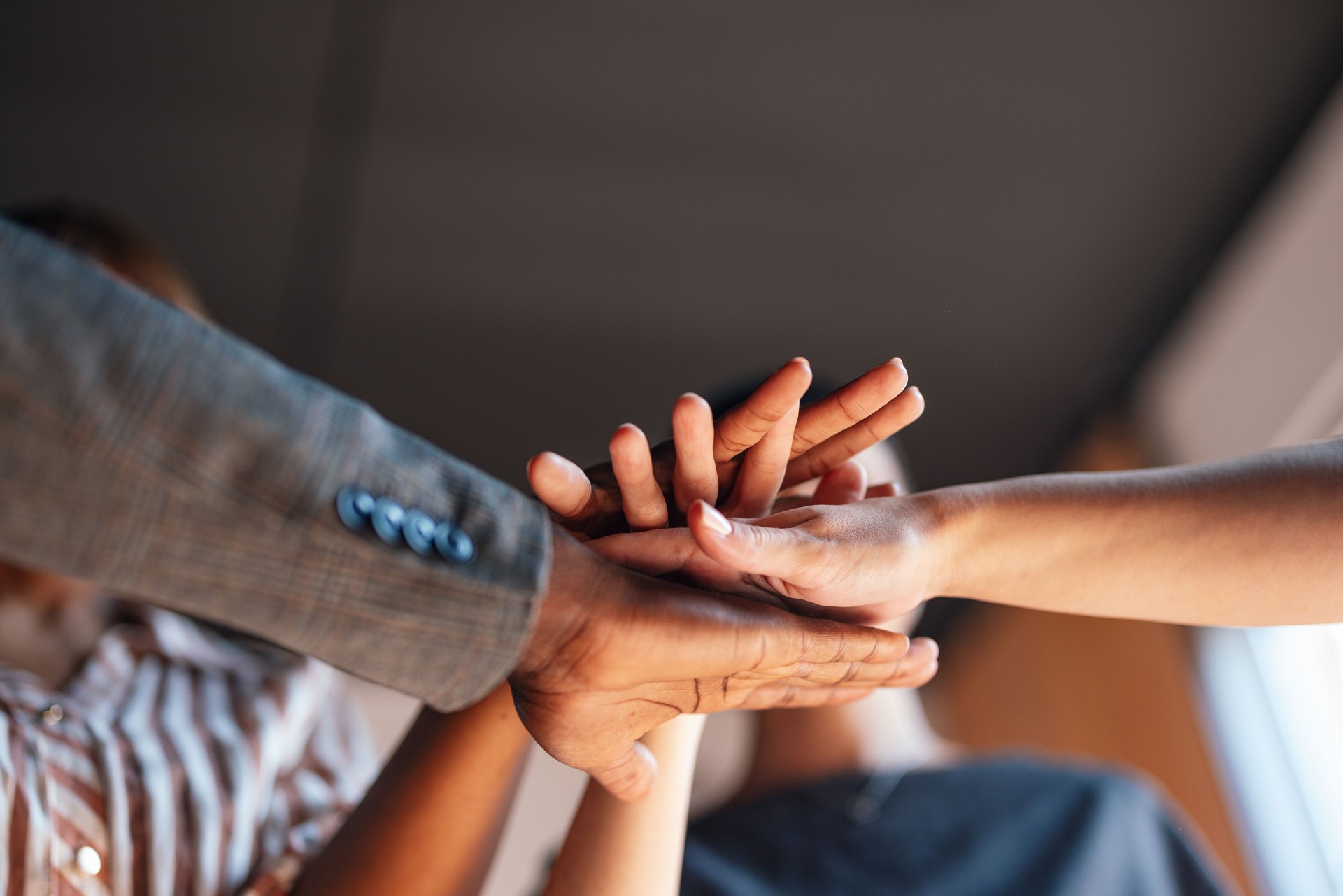 Group of Hands Joining Together in Teamwork Gesture